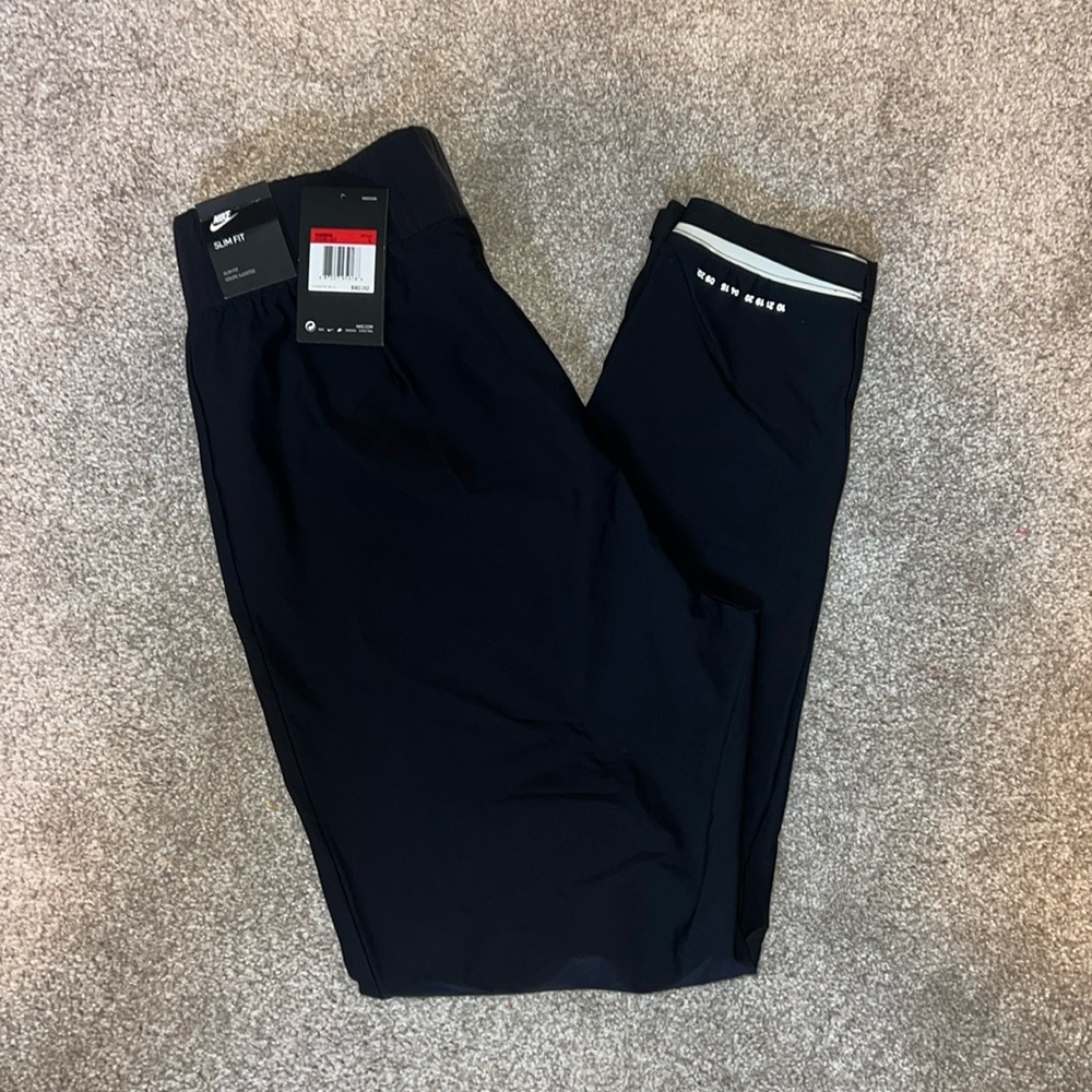 Nike woman’s tech pack pants. New with tags size large. Slim fit.